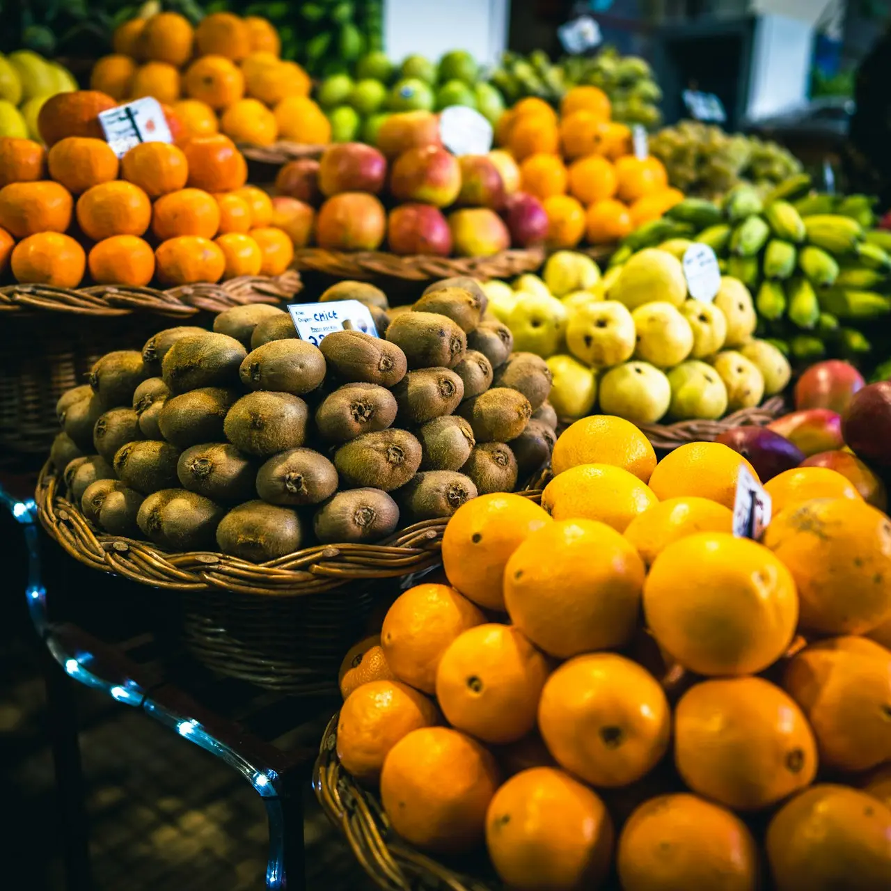 a bunch of baskets filled with different types of fruit